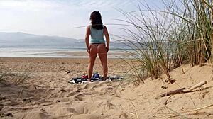 Curvy brunette MILF strips naked and works out on the beach