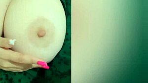 look at this young beauty in green dress playing with her huge tits, isn't she hot?