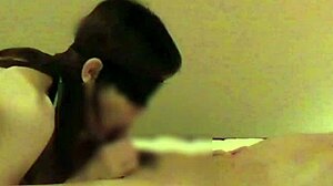 Beautiful woman in Chinese dress stimulates penis with handjob and blowjob