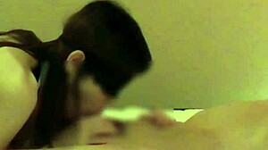 Beautiful woman in Chinese dress stimulates penis with handjob and blowjob