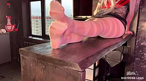 Goddess in white pantyhose wiggling her nylon feet and toes on a table