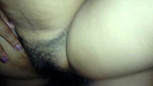 My wife spreads her legs wide, revealing her hairy vagina for a close look.
