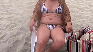 She shows off her big pussy lips on the beach, fingering her clit until a stranger fucks her.