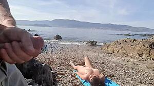 Nudist milf sucks exhibitionist’s dick right on the beach.