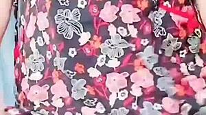 Pink shirt sissy crossdresser with big butt teases in mini skirt, contrasting cute ladyboy charm with gay desires