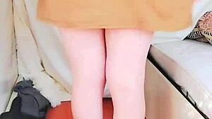 Pink shirt sissy crossdresser with big butt teases in mini skirt, contrasting cute ladyboy charm with gay desires