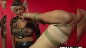 Kaera Cruz in bondage dominated by Maxine X in a lesbian scene.