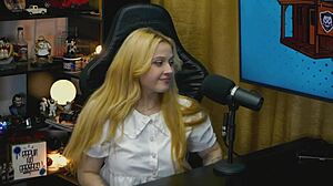 A branquinha from viamms poses on podcast table for show.