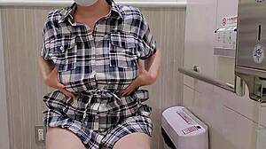 a married japanese woman sneaks away to masturbate in a store toilet.