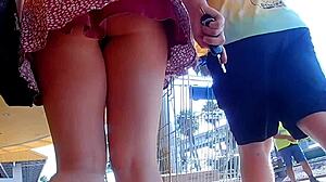 In this public outdoor scene, a skirt flies up in slow motion for an upskirt view