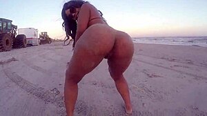 Ebony woman dances naked on the beach