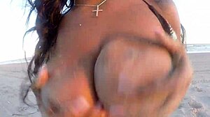 Ebony woman dances naked on the beach