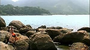 mature man fucks exotic babe in cap and sunglasses on seaside stones