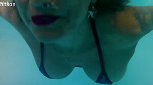 MELISSA THE MERMAID SWIMS IN POOL WITH TATTOOS BROWN EYES