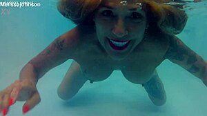 MELISSA THE MERMAID SWIMS IN POOL WITH TATTOOS BROWN EYES
