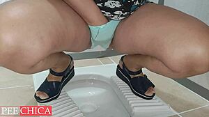 hot sexy girl in pee panties caught in public toilet stall