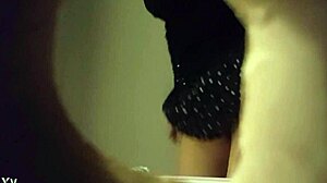 Hidden cam catches babe peeing in white panties through wall hole