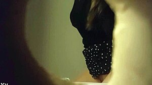 Hidden cam catches babe peeing in white panties through wall hole