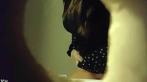 Hidden cam catches babe peeing in white panties through wall hole