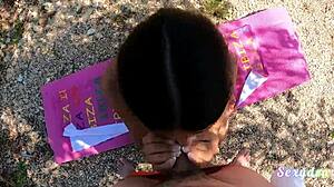 Seductress performs striptease by the lake at sunset