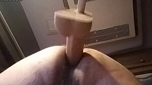 She's bent over in doggystyle, using huge dildo solo for intense pleasure in private