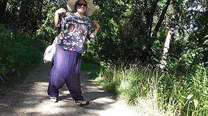 Hairy mature flashes chubby beaver in public park under skirt.