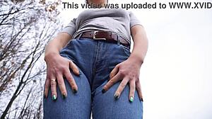 milf teasing her big cameltoe in blue jeans outdoors
