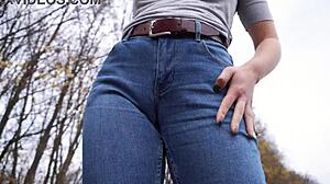 milf teasing her big cameltoe in blue jeans outdoors