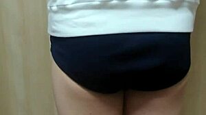 Japanese amateur plays anal in schoolgirl uniform, shorts, and see-through underwear.