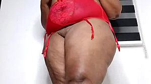 Curvy ebony housewife Mara Exotic slips into see-through red lingerie for a teasing solo session. She shakes her thick thighs and big ass while fingering her fat clit close up.