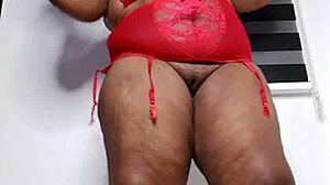 Curvy ebony housewife Mara Exotic slips into see-through red lingerie for a teasing solo session. She shakes her thick thighs and big ass while fingering her fat clit close up.