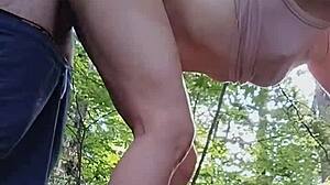 She sucks his cock in the forest while amused by honking