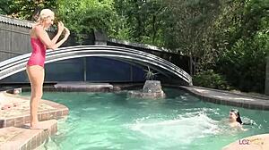 playful lesbian teens play at the pool