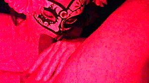 Masked in the red light sucking on something