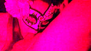 Masked in the red light sucking on something