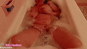 kity hudson enjoys bath tub time with her curvy figure