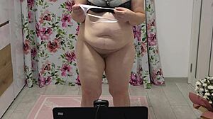 chubby woman shaking in different panties near webcam, showing figure at home