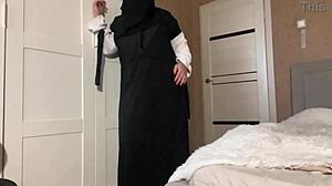 Stepmom in hijab shows pantyhose to her stepson, teasing her wet pussy.