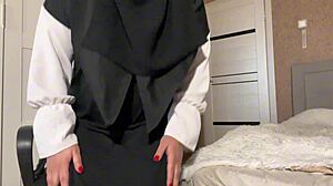 Stepmom in hijab shows pantyhose to her stepson, teasing her wet pussy.