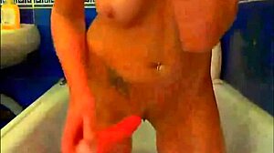 tattooed model plays with glass dildo