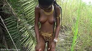 hot african native woman prepares a meal in the jungle kitchen
