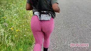Big ass ebony in leggings running alone in the forest.