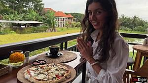 Girl with cum on face eats pizza in cafe