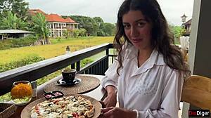 Girl with cum on face eats pizza in cafe