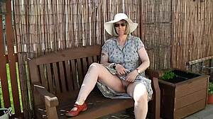 Naughty girl strips naked in the garden, feeling free outdoors.