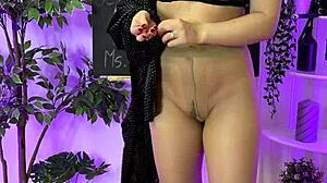 Sexy milf putting on leather harness suit