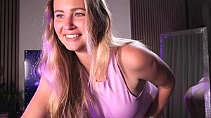 a blonde babe dances seductively in pink bodysuit before mirror play