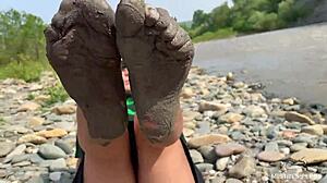 goddess hikes up leggings to reveal her dirty torn pantyhose nylon feet toes close up by the river