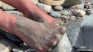 goddess hikes up leggings to reveal her dirty torn pantyhose nylon feet toes close up by the river