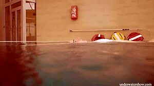 Lola dives underwater her big natural tits swaying seductively in the pool